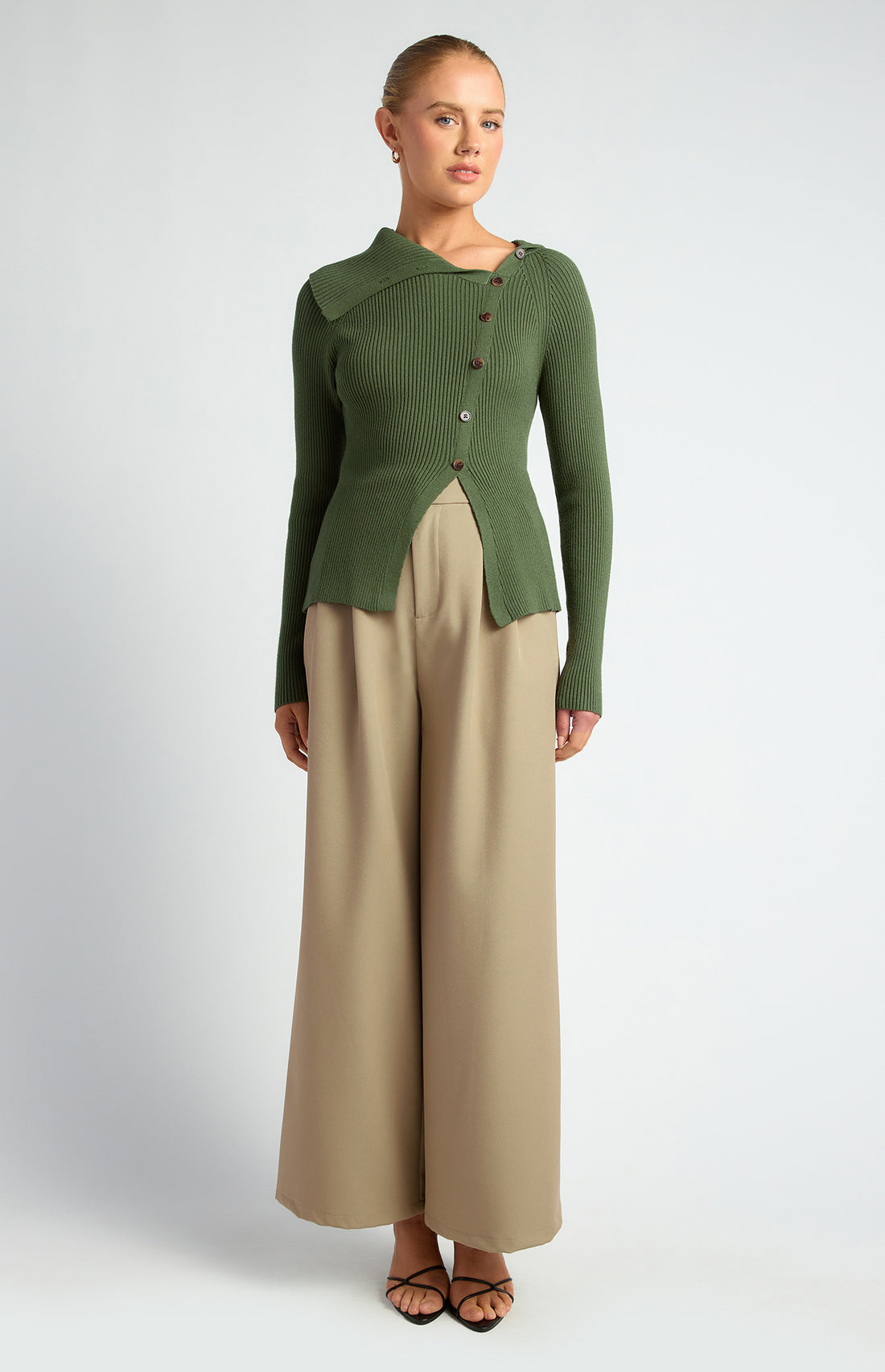 Model wearing women’s forest green draped neck knit top