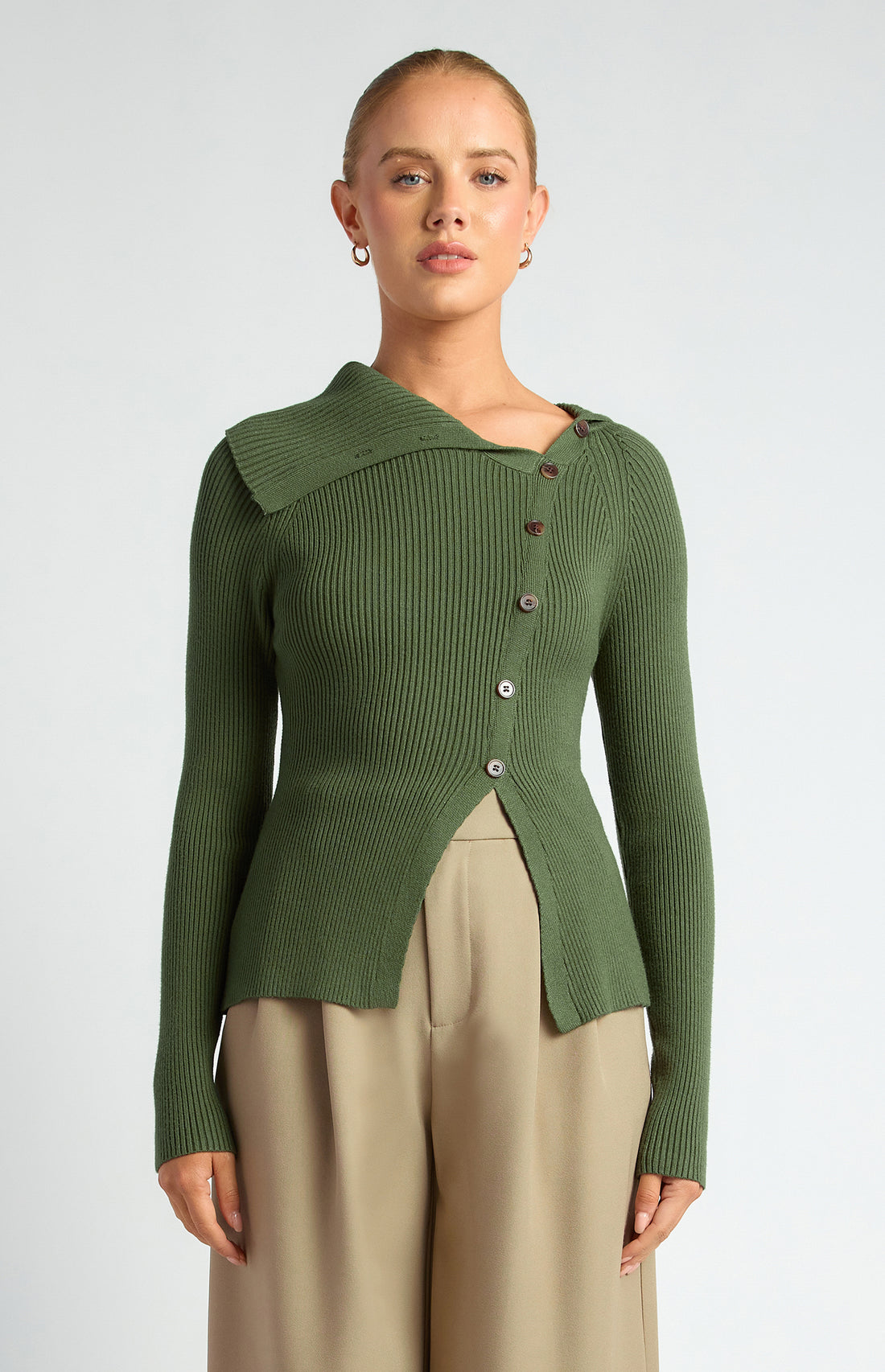 Model wearing women’s forest green draped neck knit top